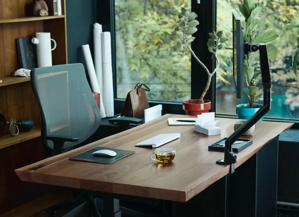 A monitor arm mounted on a standing desk